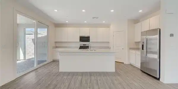 Image 2: A well-lit, open-concept kitchen and living area w