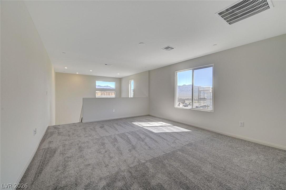 Image 4: A spacious, naturally illuminated loft area offers