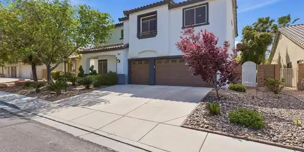 Image 2: A classic Spanish tile roof and concrete driveway