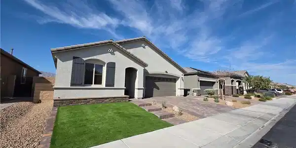 Image 2: Neat desert landscaping pairs with stucco siding u