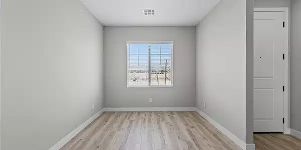 Image 2: Smooth wood-look flooring and a wide window with b