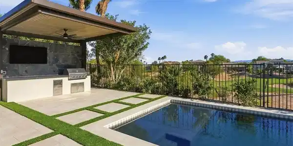Image 3: An inviting outdoor oasis features a private pool