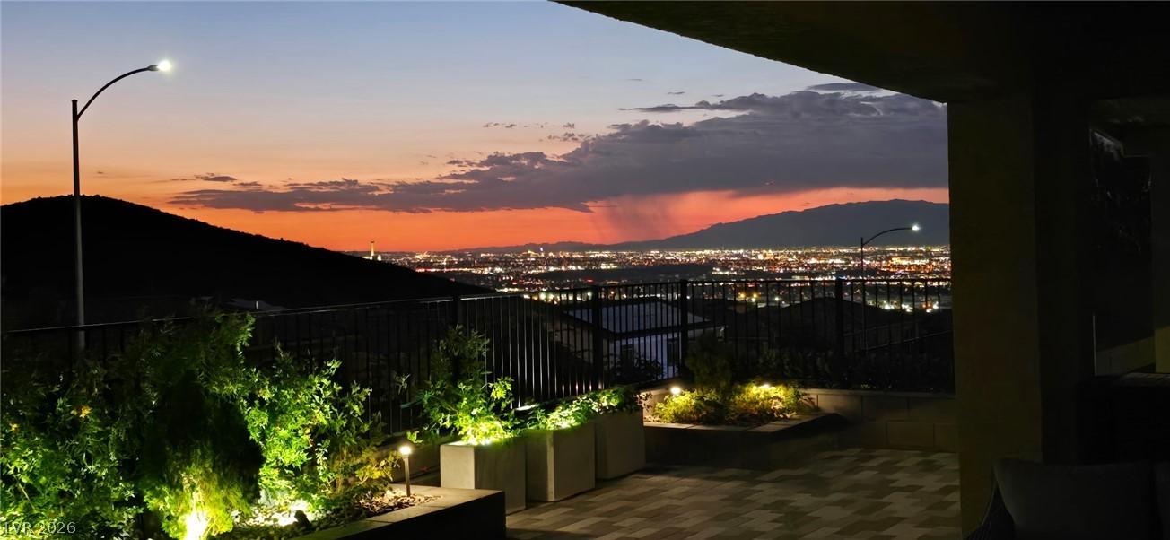 Image 3: City lights twinkle across the distant mountains u