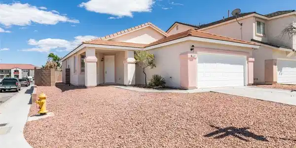 Image 2: This desert-landscaped home features a welcoming e