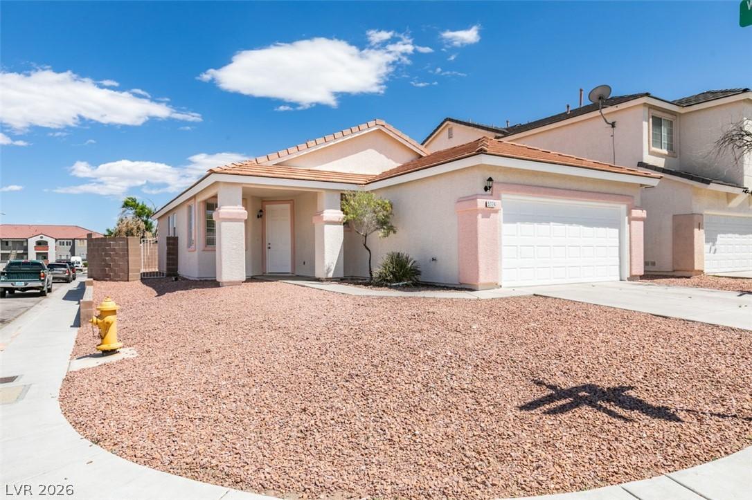 Image 2: This desert-landscaped home features a welcoming e