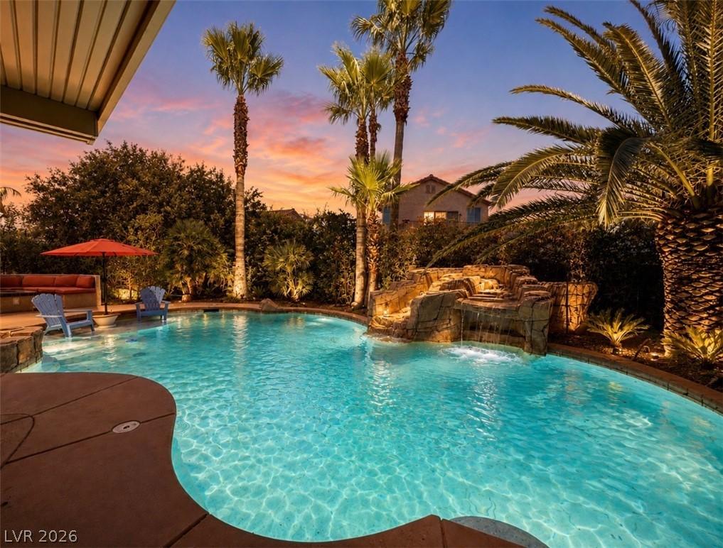 Image 2: An inviting backyard oasis offers a sparkling pool