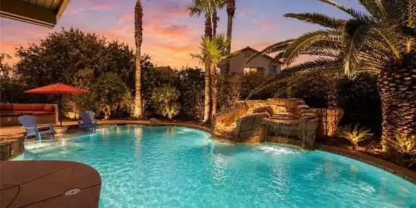 Image 2: An inviting backyard oasis offers a sparkling pool