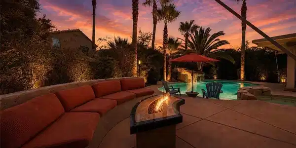 Image 3: An inviting fire pit seating area overlooks a refr