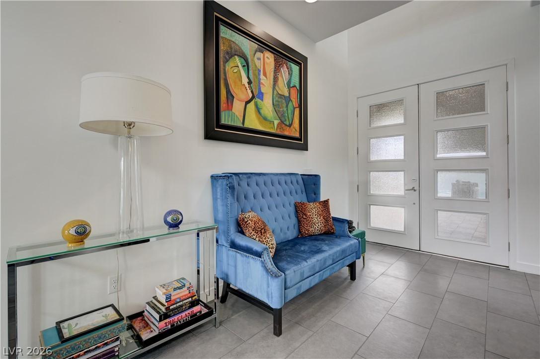 Image 4: Living area with french doors and tile patterned f