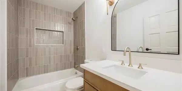 Image 3: A refined bathroom featuring a sleek vanity, an ar