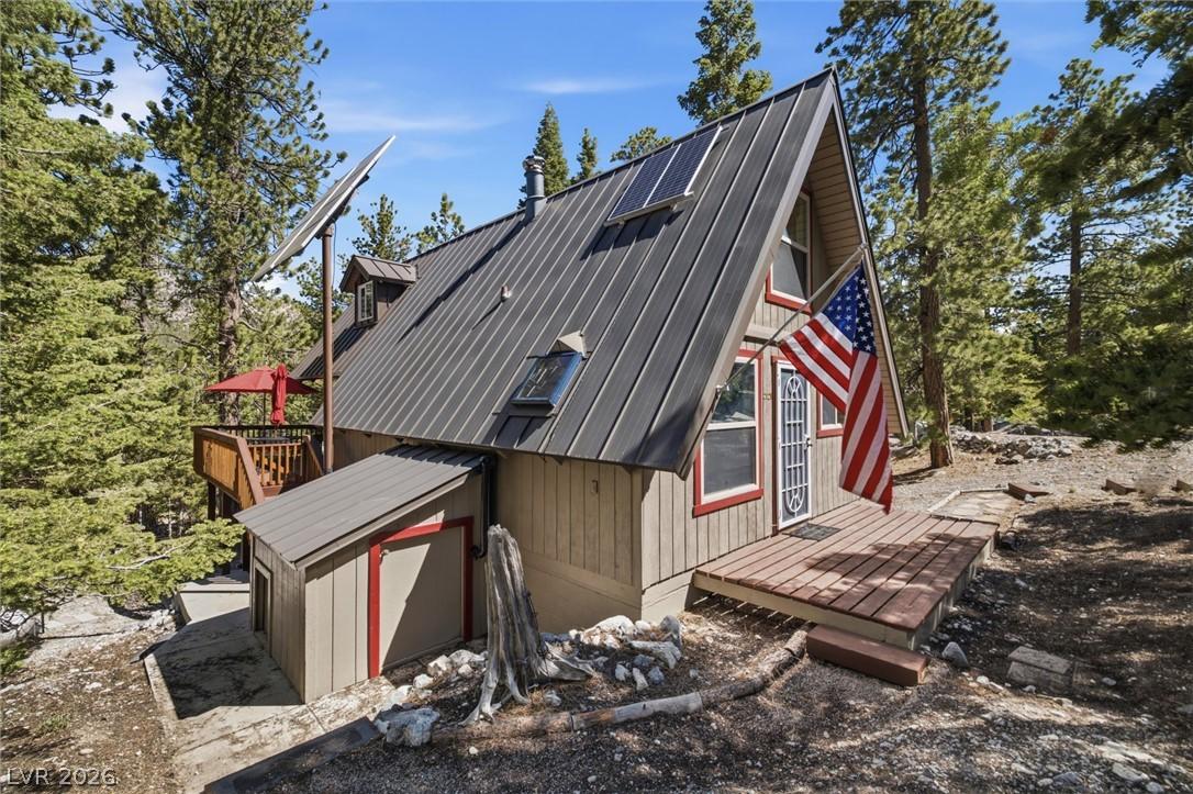 Image 2: Perched among towering pines, this A-frame cabin o