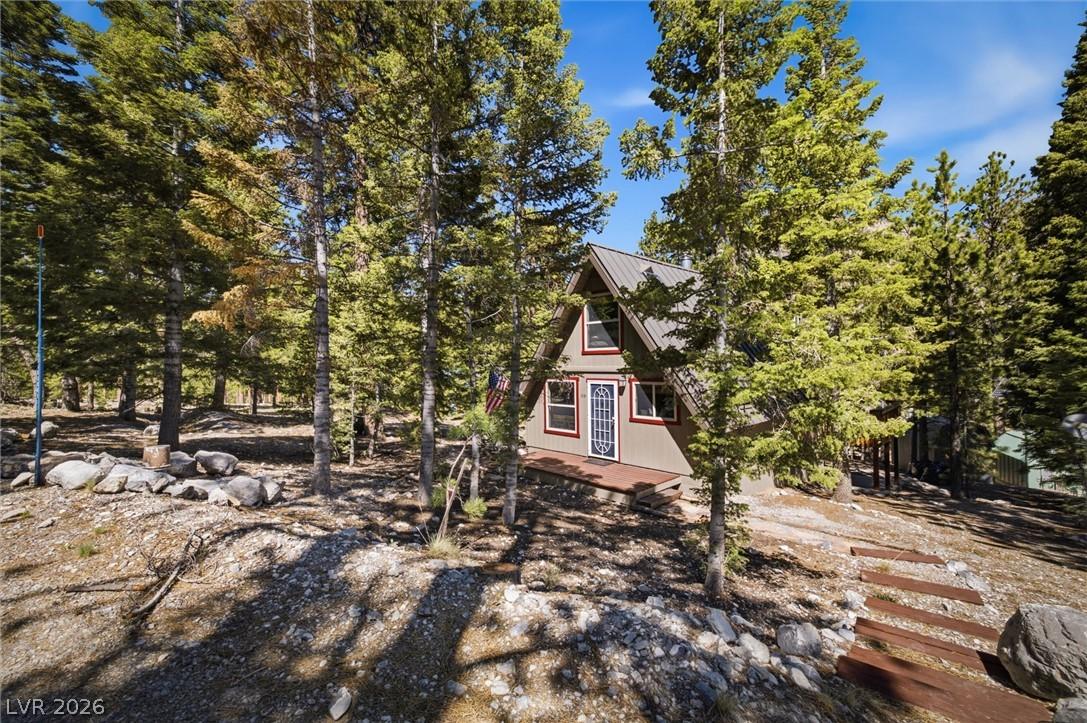 Image 3: An inviting A-frame dwelling nestled among towerin