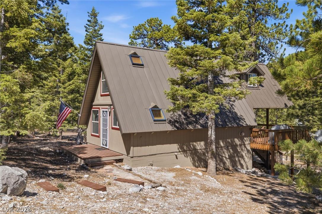 Image 4: Nestled among towering pines, this A-frame cabin f