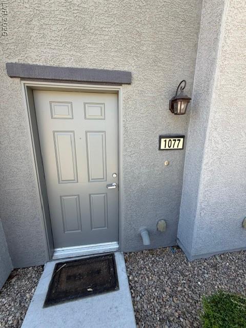 Image 3: A welcoming entry, with a textured stucco exterior