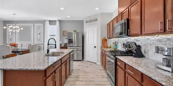 Image 4: Rich cherry colored wood cabinetry and expansive g