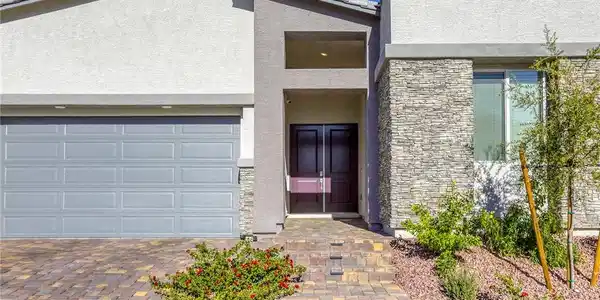 Image 3: Inviting exterior with paver driveway, 3-car garag