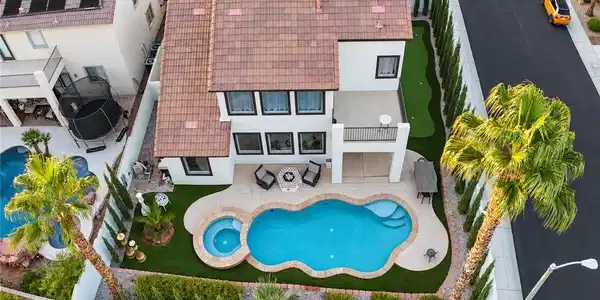 Image 3: A sparkling pool and integrated spa highlight this