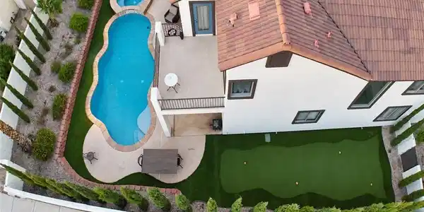 Image 4: A private backyard oasis features a glistening poo