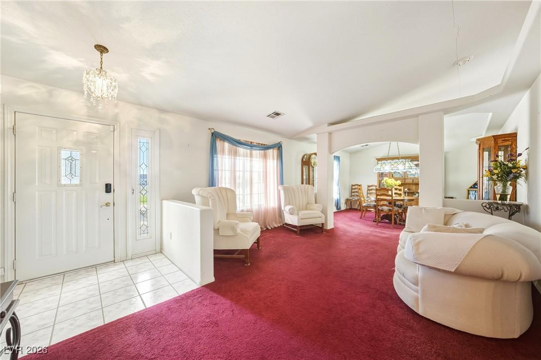 Image 4: Foyer with a chandelier, arched walkways, light ca