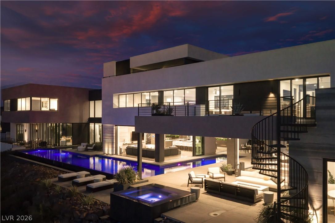 Image 2: A striking modern residence boasts an illuminated