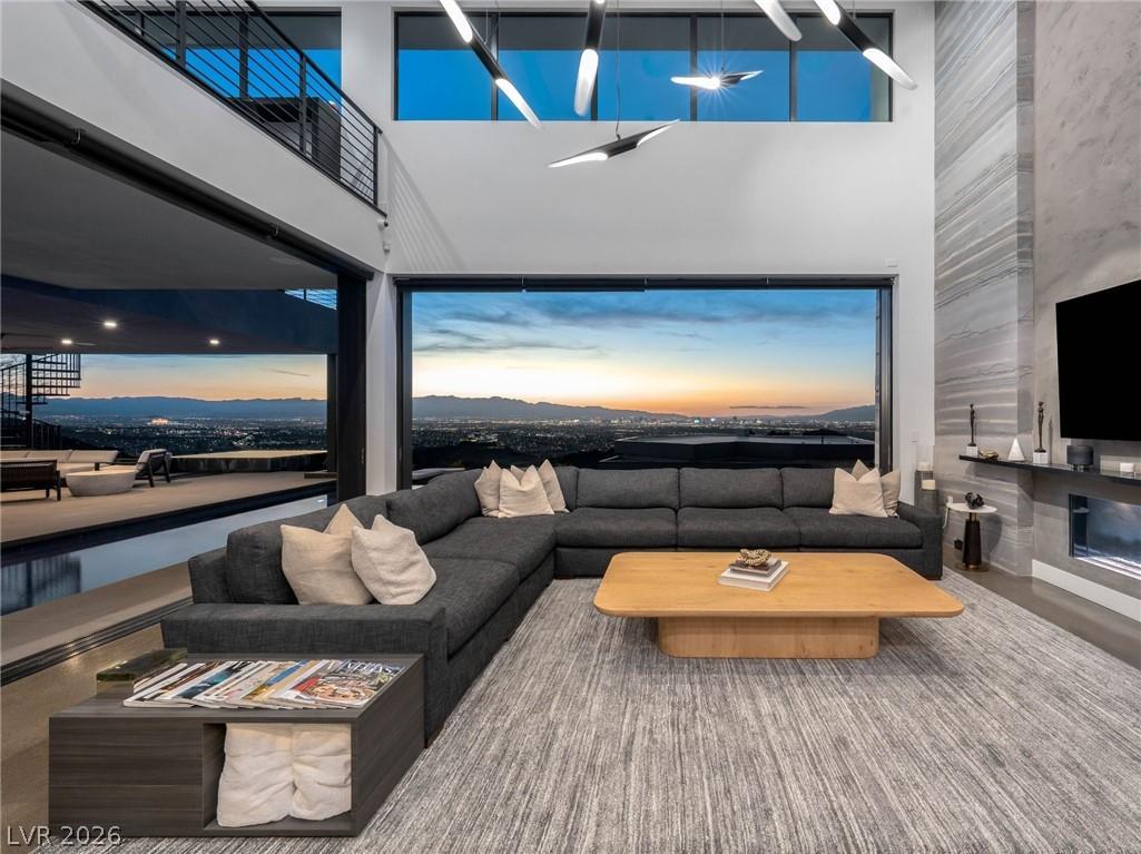 Image 4: City views and sunset hues elevate this living roo