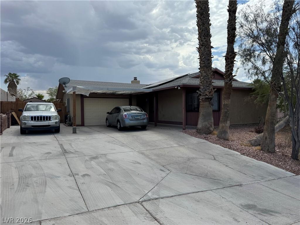 Image 3: Concrete driveway leads to this practical home wit