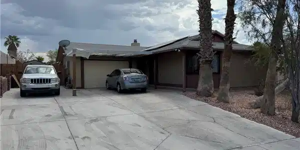 Image 3: Concrete driveway leads to this practical home wit