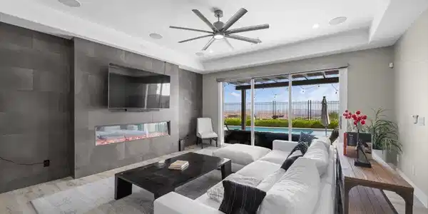 Image 4: A modern fireplace accent wall anchors this comfor