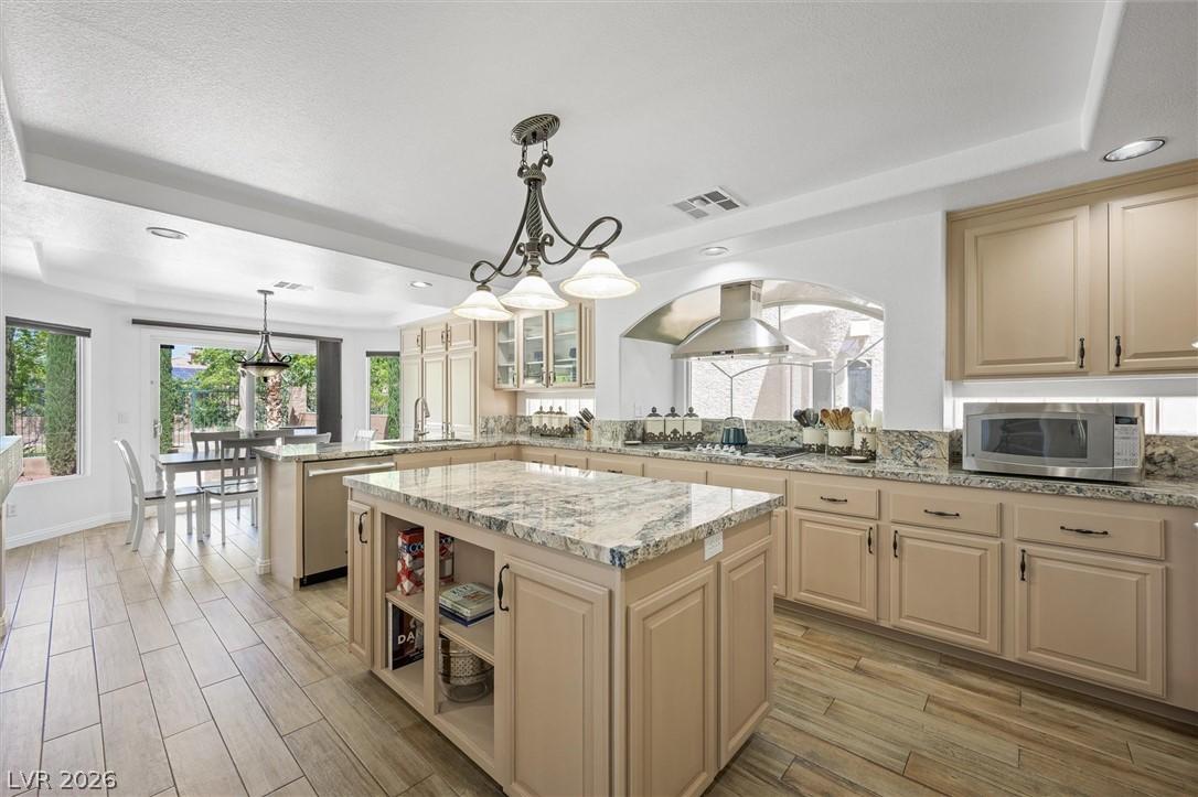 Image 4: An inviting kitchen with a granite island, rich ca