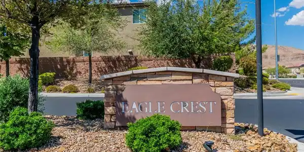 Image 2: An inviting stone community entrance sign sits sur