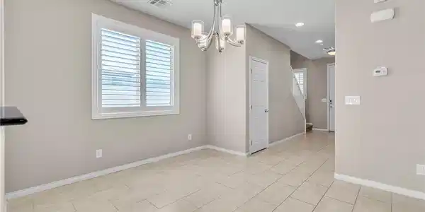 Image 4: Tiled flooring and elegant lighting define this ve