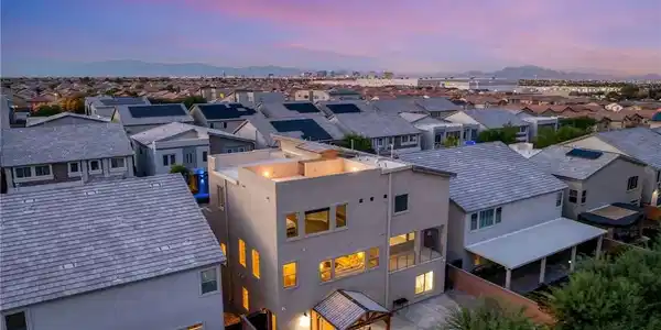 Image 2: Dramatic sunset skies frame a modern multi-level r