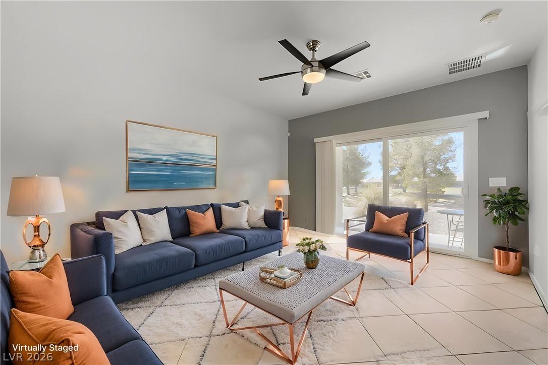 Image 4: An inviting living room features a ceiling fan, ti