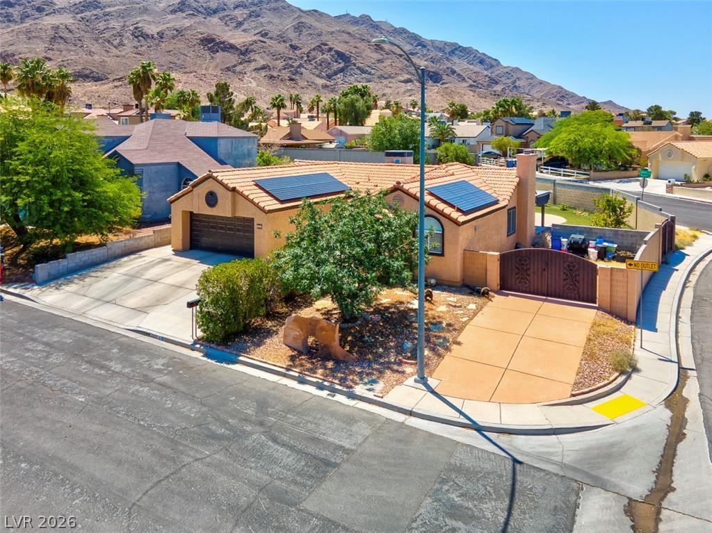 Image 4: An inviting exterior with desert landscaping and a