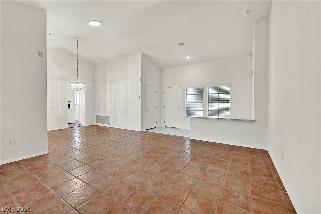 Image 2: Vast living area featuring warm ceramic tile floor