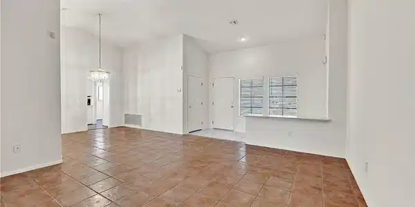 Image 2: Vast living area featuring warm ceramic tile floor