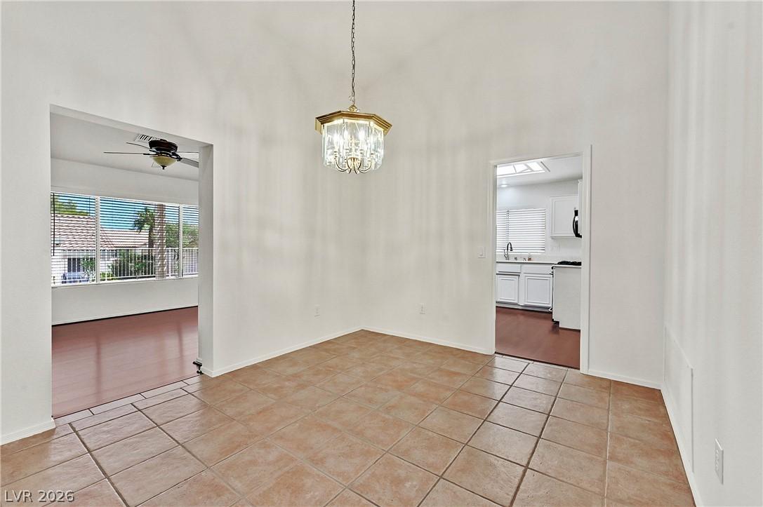Image 4: A well-lit dining area features a graceful chandel