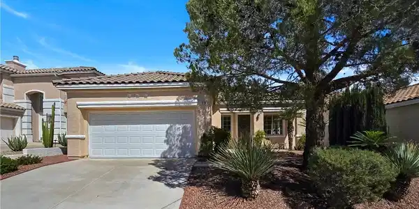 Image 2: Desert landscaping and a tiled roof enhance this s