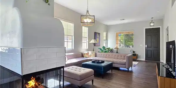 Image 4: An inviting fireplace warms this airy living area