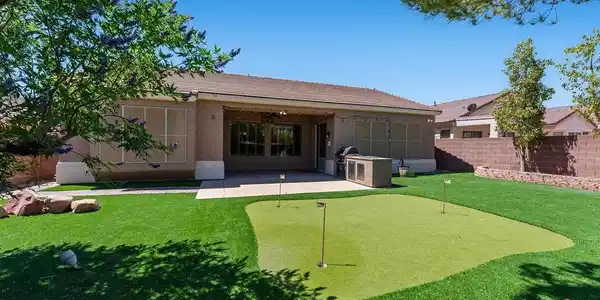 Image 2: This private yard features a putting green and an