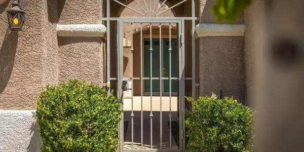 Image 3: This inviting entrance features an ornamental iron