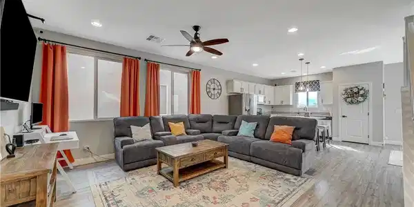 Image 4: An open-concept living area flows seamlessly into