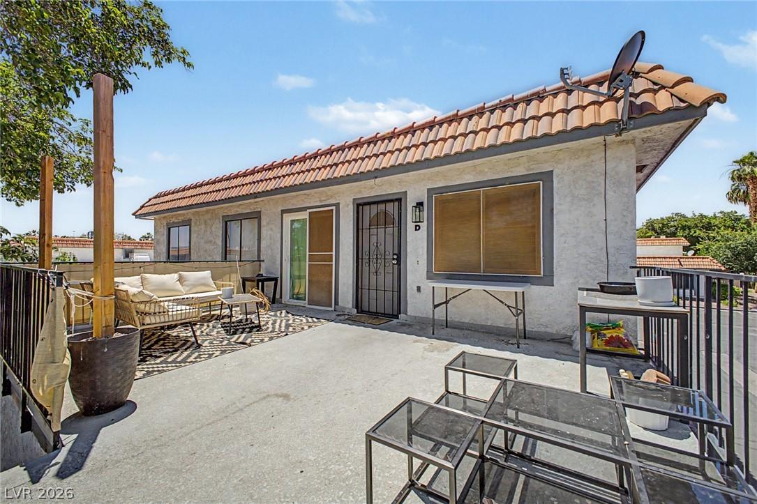 Image 3: An inviting exterior patio with a tiled roof offer