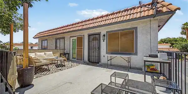 Image 3: An inviting exterior patio with a tiled roof offer