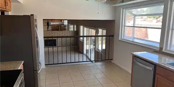 Image 3: This eat-in kitchen has ceramic tile flooring, gra