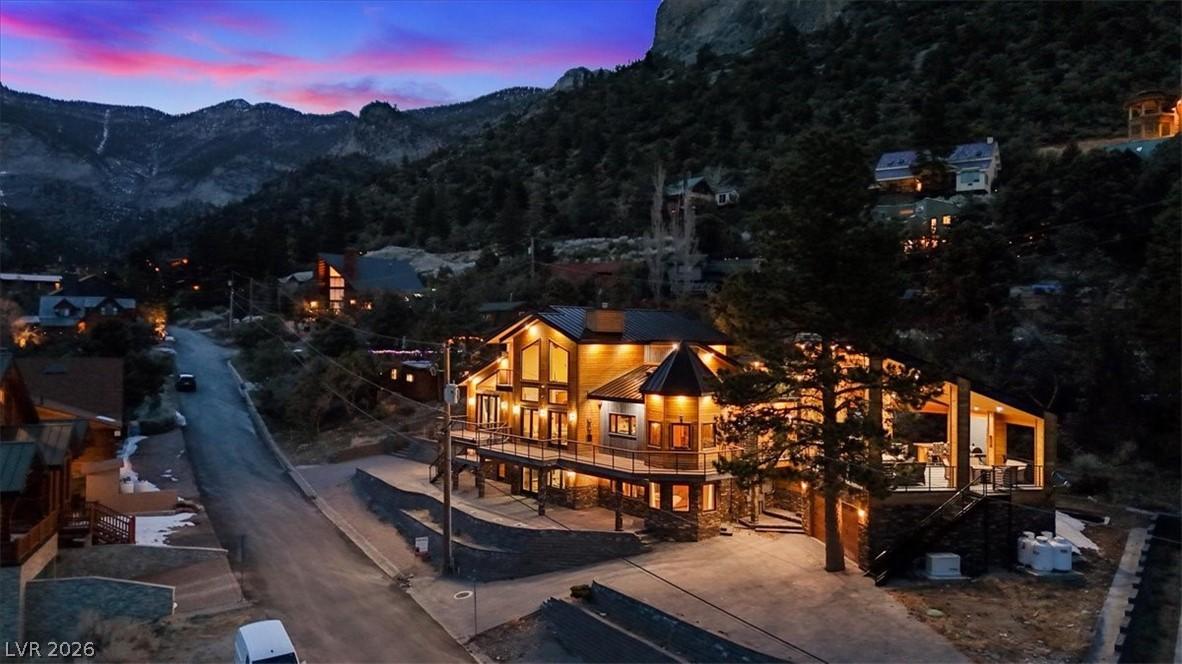 Image 3: Perched on a mountain slope, this home features il