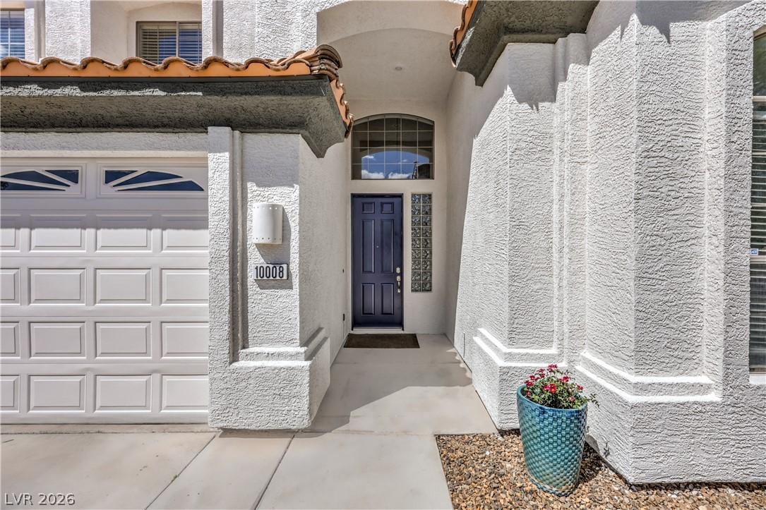 Image 2: A welcoming front entrance featuring a deep blue d