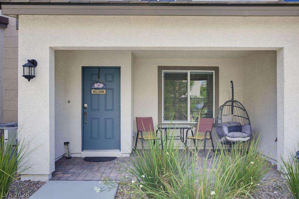 Image 2: A welcoming front entry features a serene sitting