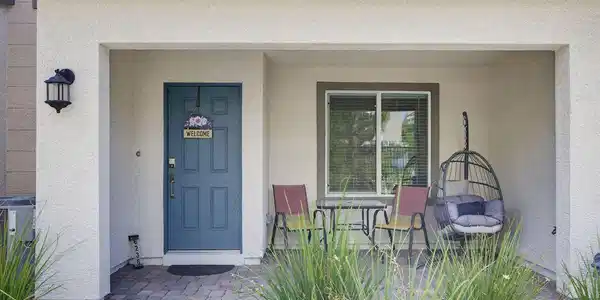 Image 2: A welcoming front entry features a serene sitting