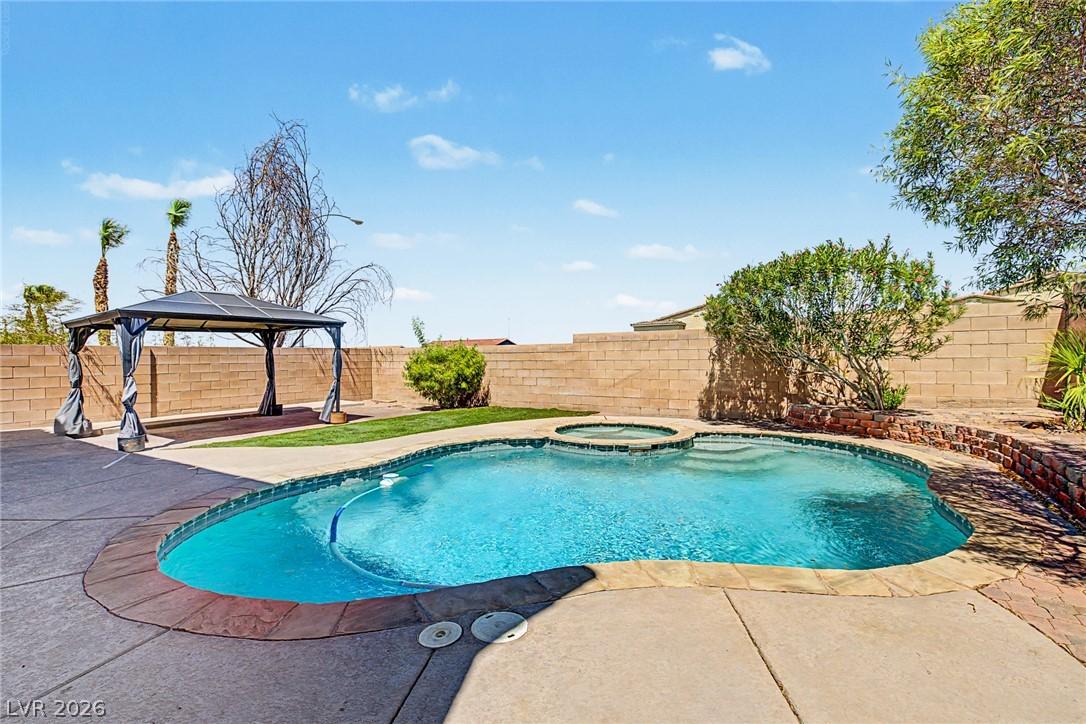 Image 2: A private backyard oasis features a glistening poo